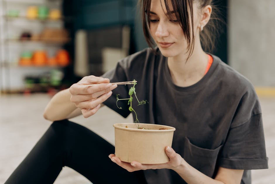 Young woman enjoying a healthy salad indoors, focusing on balanced nutrition and healthy living.